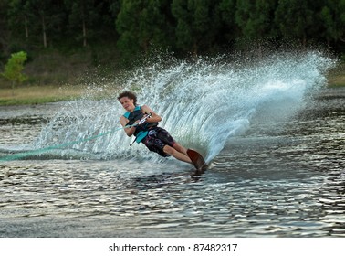 Young Man Waterskiing On Lake