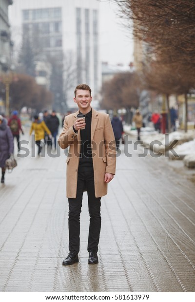 black shirt and brown trousers