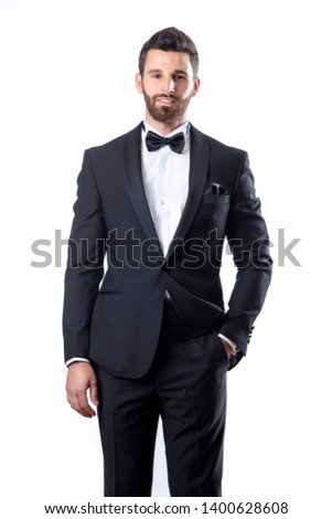 A young man wearing a black suit on a white background