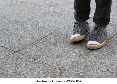 Young Man Wearing Brand New Converse,  Converse All Stars The World’s Most Popular Sneaker, Wearing Brand New Black And White  Old School Shoes In A Grey Background Street , Legs Wearing Black Jeans