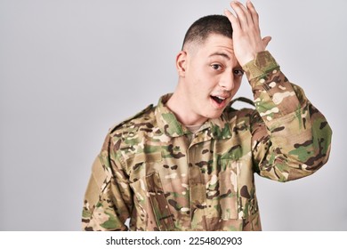 Young man wearing camouflage army uniform surprised with hand on head for mistake, remember error. forgot, bad memory concept.  - Shutterstock ID 2254802903