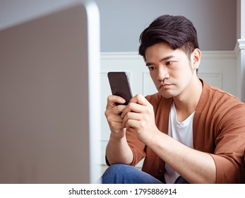 Young man wearing casual clothes and using smartphone