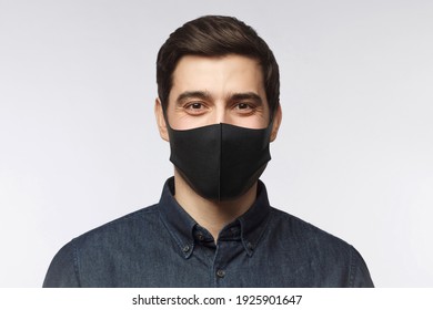 Young Man Wearing Denim Shirt And Black Mask Standing Isolated On Gray Background