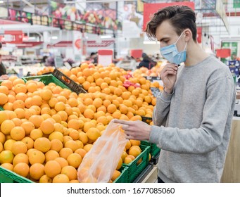 Young man wearing disposable medical mask shopping in supermarket during coronavirus pneumonia outbreak. Protection and prevent measures while epidemic time. Covid-19 person