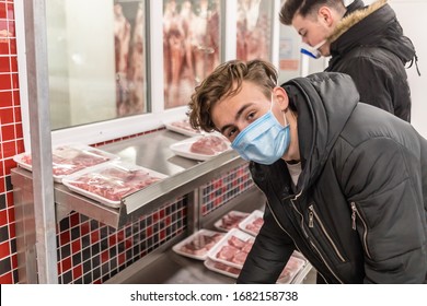 Young man wearing disposable medical mask shopping in supermarket during coronavirus pneumonia outbreak. Protection and prevent measures while epidemic time. Covid-19 person