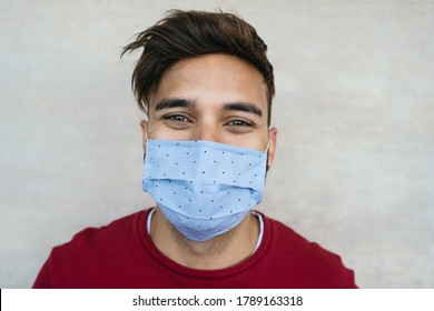 Young Man Wearing Face Mask Portrait - Latin Boy Using Protective Facemask For Preventing Spread Of Corona Virus - Health Care And Youth Millennial People Concept 