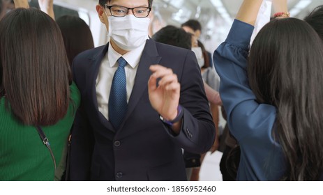 Young Man Wearing Face Mask Travels On Crowded Subway Train . Coronavirus Disease Or COVID 19 Pandemic Outbreak And Urban Lifestyle Problem In Rush Hour Concept .