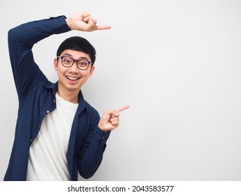 Young man wearing glasses gesture point finger at copy space portrait white background - Shutterstock ID 2043583577