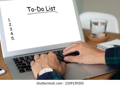 Young Man Wearing Plaid Shirt Using Laptop Write To Do List On Desk. He Always Writes A To Do List Before Starting Work. Planning And Design Concept. 