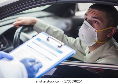 Young Man Wearing Protective Face Mask In Drive-thru Coronavirus Car Testing Or Vaccination Center,answering Patient Health Check Survey,nurse,doctor Or Technician Filling Out Clipboard Questionnaire 
