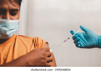 Young Man Wearing A Protective Mask Show Plaster On The Shoulder After Vaccination Against Covid-19 Health Care Guidelines Health Protection Vaccine Effects
