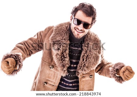 a young man wearing a sheepskin coat isolated over a white background