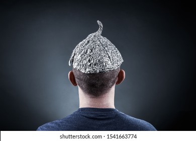 Young man wearing a tin foil hat 