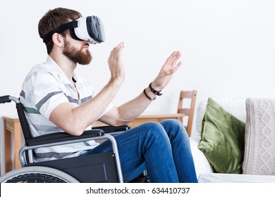  Young Man Wearing Virtual Glasses Sitting On His Wheelchair