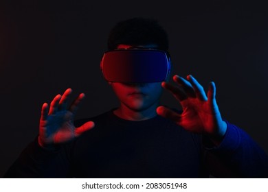 Young Man Wearing VR Goggles. Metaverse Technology Virtual Reality Concept. Virtual Reality Device, Simulation, 3D, AR, VR, Innovation And Technology Of The Future On Social Media.