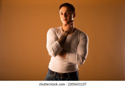 Young Man Wearing White Blouse Isolated In Studio