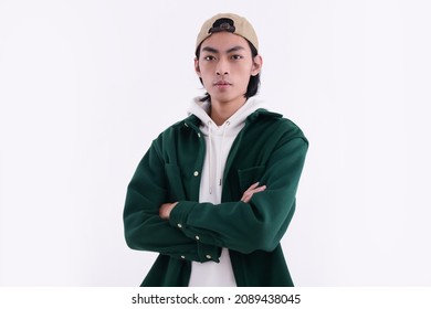 Young Man Wearing A White Hoodie With Green Shirt With Hat Arms Crossed,in Studio

