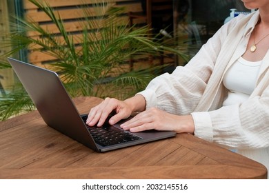 Young Man Wearing White Linen Shirt Working On His Laptop By The Pool. Male Travel Blogger Typing On Keyboard. Perks Of Being A Freelancer. Close Up, Copy Space, Background.