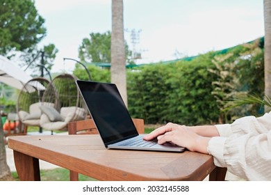 Young Man Wearing White Linen Shirt Working On His Laptop By The Pool. Male Travel Blogger Typing On Keyboard. Perks Of Being A Freelancer. Close Up, Copy Space, Background.