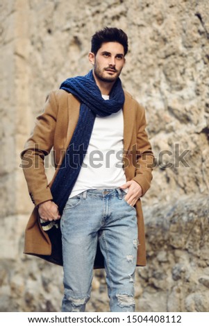 Similar – Thoughtful young man sitting on an urban bench