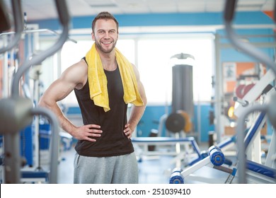 Young Man With Weight Training Equipment In Sport Gym