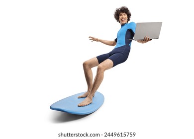 Young man in a wetsuit riding a surfboard and holding a laptop computer isolated on white background - Powered by Shutterstock