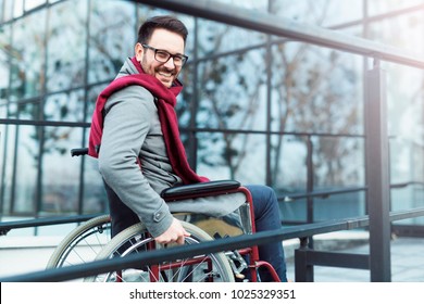 Young Man In The Wheelchair Going Outside