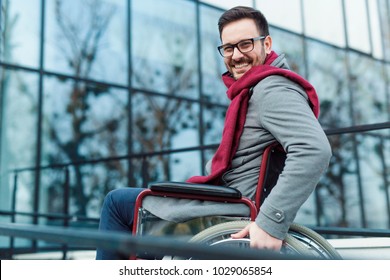 Young Man In The Wheelchair Going Outside And Smiling