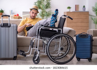 Young man in wheel-chair preparing for departure at home