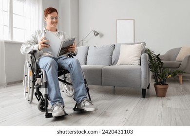 Young man in wheelchair reading magazine at home - Powered by Shutterstock