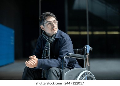 young man in wheelchair thoughtful, with a background of buildings reflect - Powered by Shutterstock