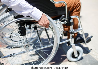 A young man in a wheelchair who can not descend the stairs. - Shutterstock ID 766175410