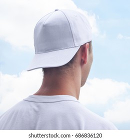 Young Man In A White Cap And T-shirt. White Baseball Cap Mockup. Close-up