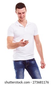 Young Man In A White Polo Shirt Holding Mobile Phone And Writing Sms