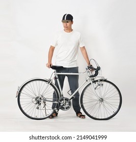 A Young Man In A White T-shirt With His Old Bicycle In A White Scene