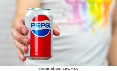 Young Man In White T-shirt Holding A Pepsi Jar