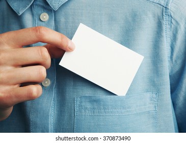 Young man who takes out blank business card from the pocket of his shirt - Shutterstock ID 370873490