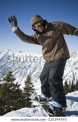 Young man in winter coat snowboarding Stock fotó © 