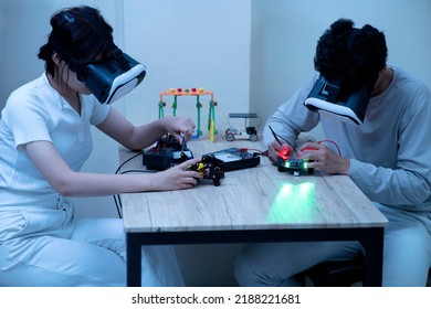 Young Man And Young Woman Amateur Inventor Testing Electronic Device Model Inventions All Wear Vr Glasses To Show High Technology