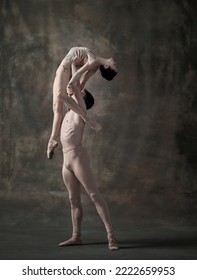 Young Man And Woman, Ballet Dancers Performing Isolated Over Dark Green Vintage Background. Holding High. Lightness. Contemporary Ballet. Concept Of Classic Dance, Artist, Beauty. Copy Space For Ad