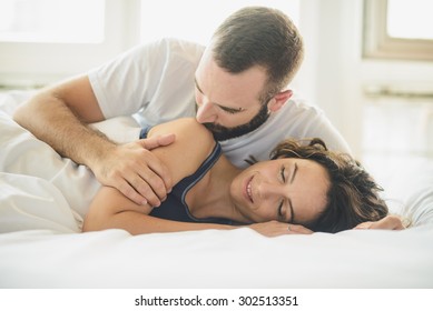 Young Man And Woman In Bed 