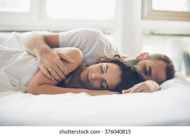 Young man and woman in bed 