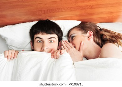 Young Man And Woman In Bed. Couple.