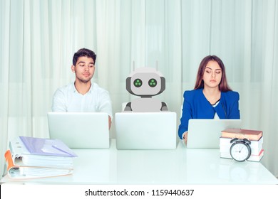 Young Man And Woman Corporate Employees With Laptops Sitting At Table With Robot Colleague And Peeking Computer Being Envy About His Much Effective Work Being Worried To Loose Jobs. Robot Vs Human.