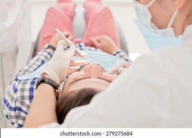 young man and woman in a dental examination at dentist - Shutterstock ID 279275684