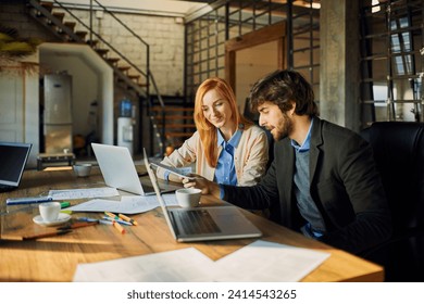 Young man and woman discussing document in office - Powered by Shutterstock