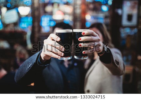 Young Man and Woman drinking Guinness 
