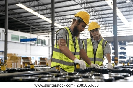 Young man and woman factory workers working in auto parts manufacturing factory Stock photo © 