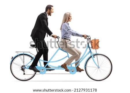 Young man and woman in formal clothes riding a tandem bicycle isolated on white background