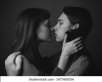 A Young Man And A Young Woman Kissing. Black And White